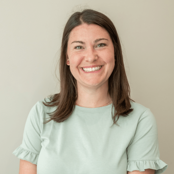 RaeAnn, Chiropractic Assistant at Foundation Family Chiropractic, smiling in a light green shirt, representing a welcoming atmosphere for patients.