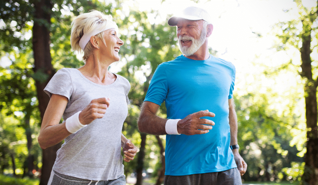 Active senior couple jogging in a park, promoting health benefits of walking and exercise for overall well-being.